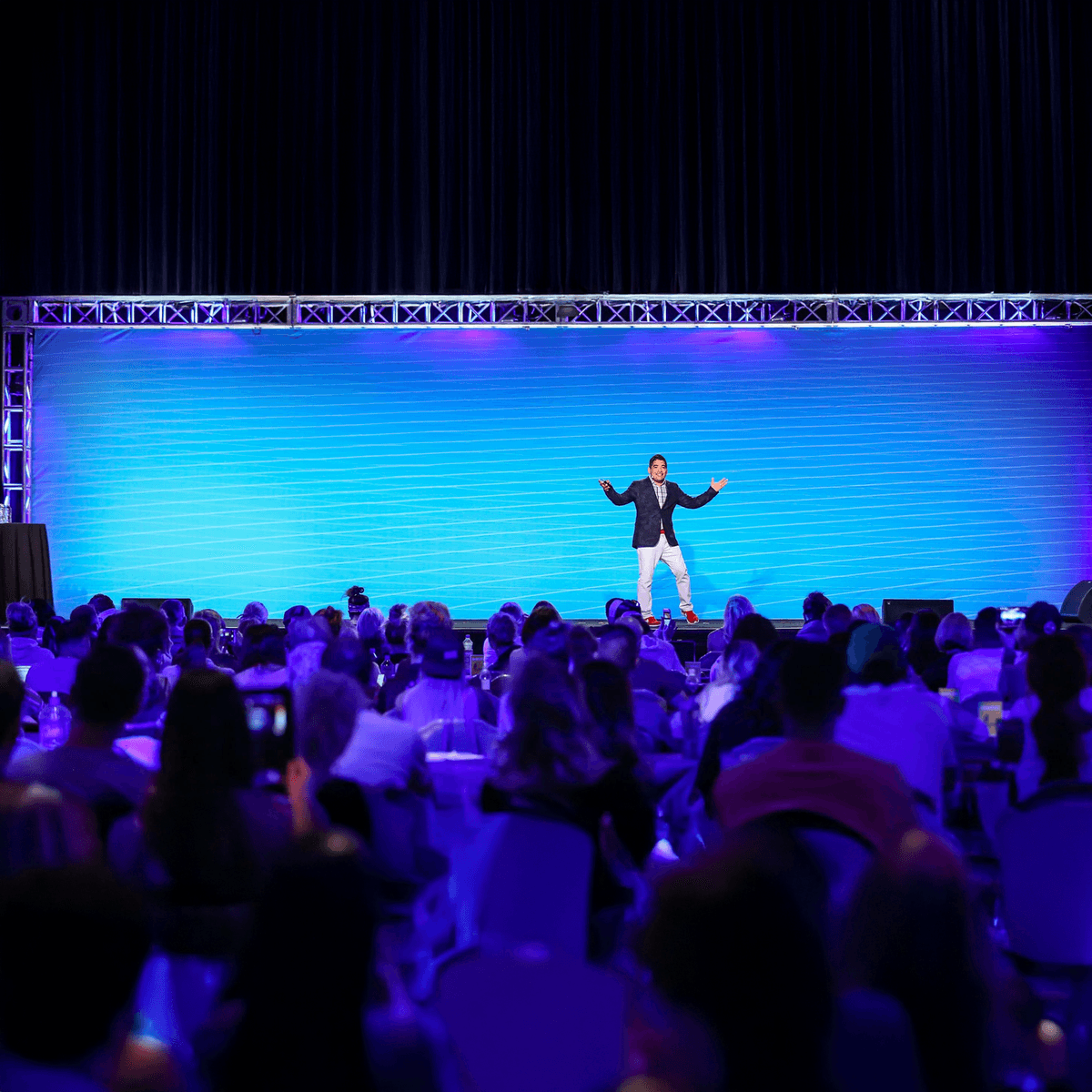 Miguel Carrasco presenting on stage